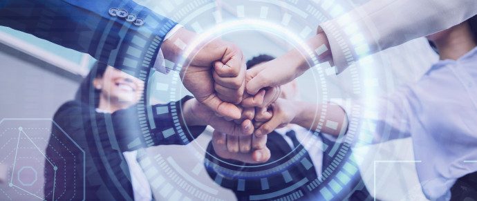 Several colleagues joining hands, overlaid with a digital interface graphic