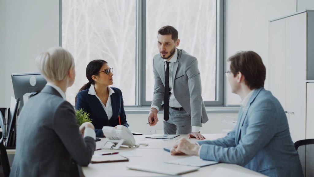 Business professionals in a serious discussion in a bright meeting room