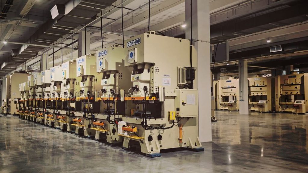 A row of industrial machines on a factory production floor